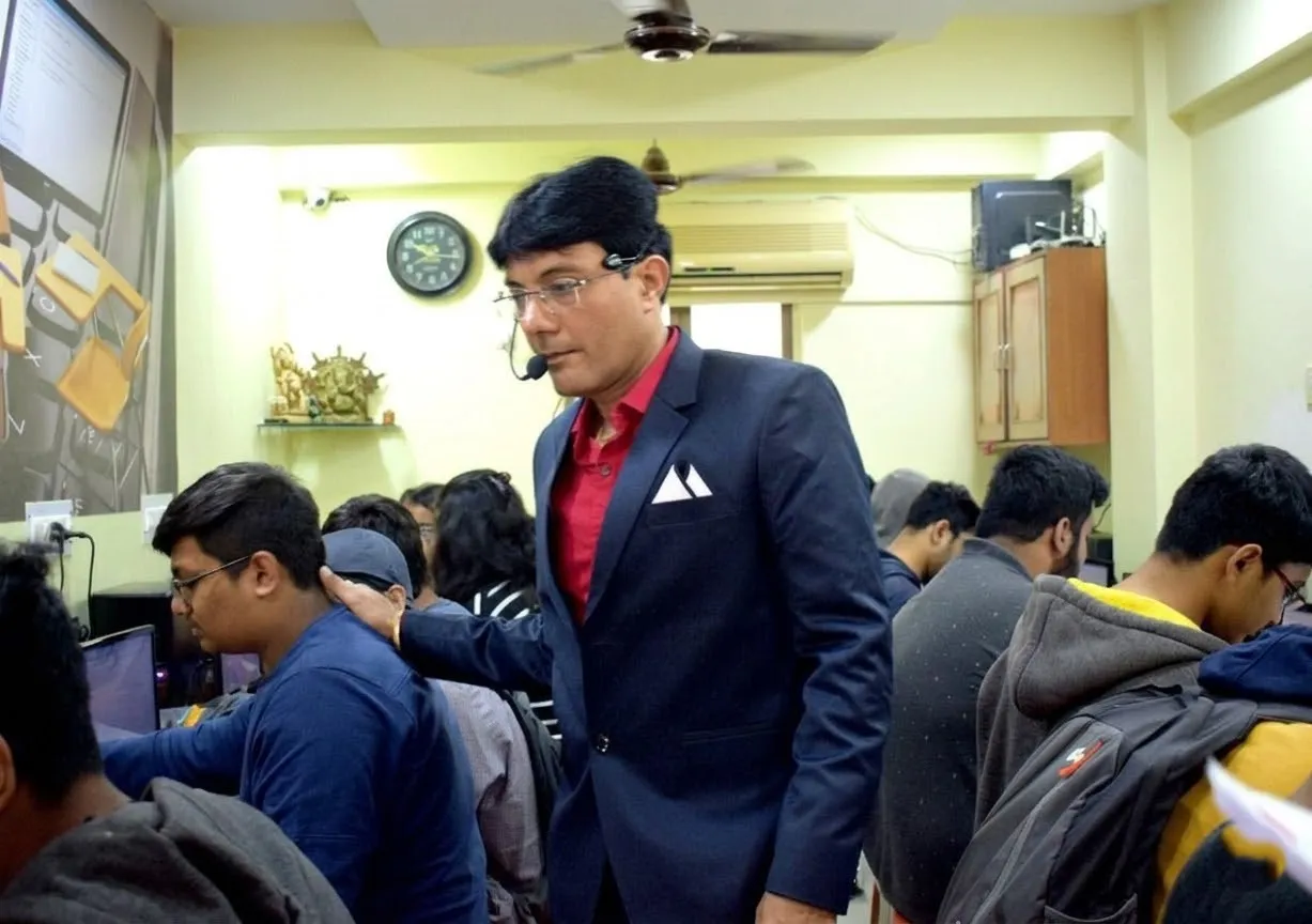 Divyakant Sir teaching practical computer classes at ECWDS, Citylight, Surat